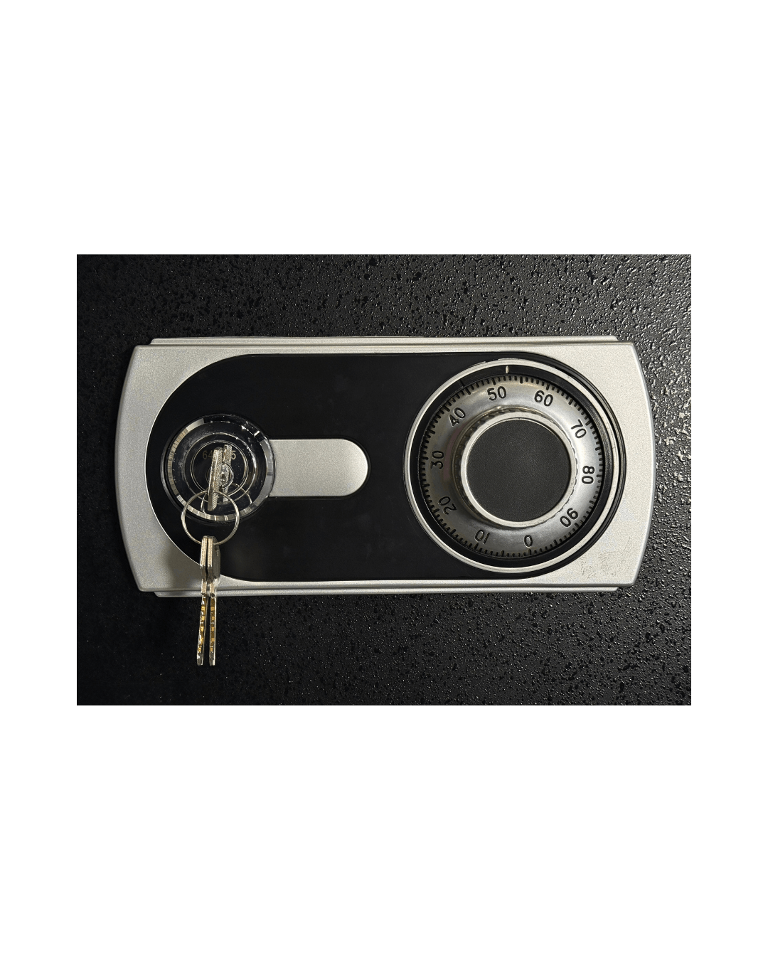 Mechanical combination lock of a fire-resistant office safe, featuring keys for added security.